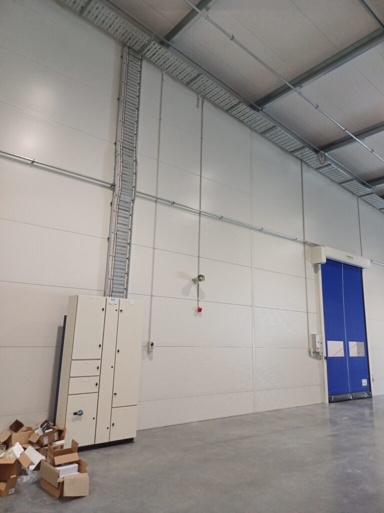 Commercial electrical installation featuring switchboard, 56 series industrial control gear, roller door wiring and LED high bay warehouse lighting